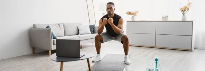 A man doing squats during a home work out